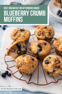 Blueberry crumb muffins arranged on a wire rack to cool. Text overlay includes recipe name.