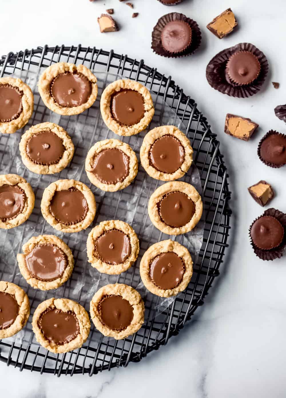 Overhead view of peanut butter cup cookies arranged on a circular cooling rack