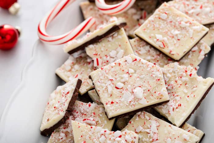 Close up of pieces of peppermint bark piled onto a white platter.