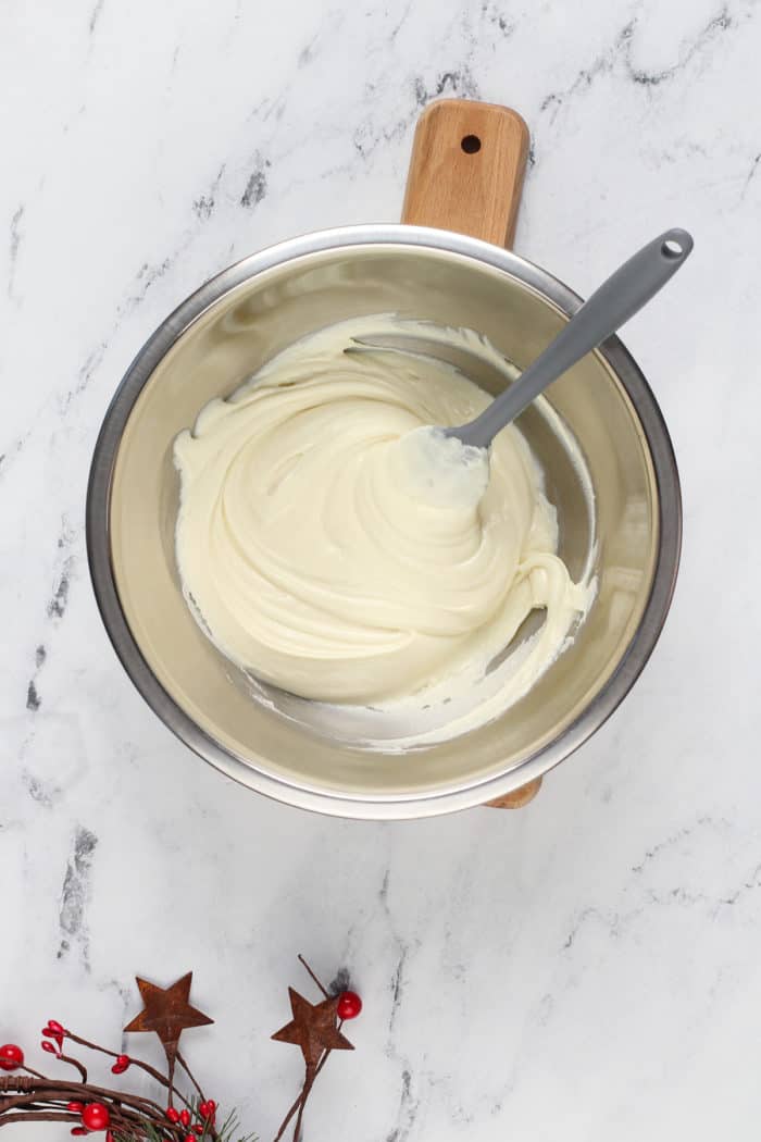 White chocolate melted in a metal bowl.