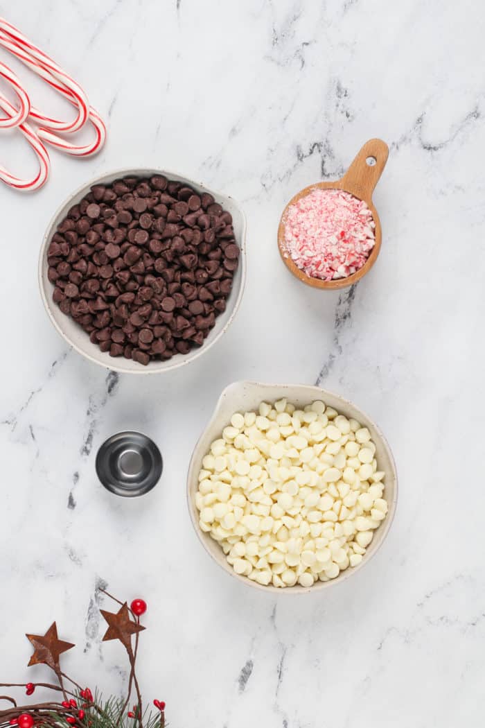 Ingredients for peppermint bark on a marble countertop.