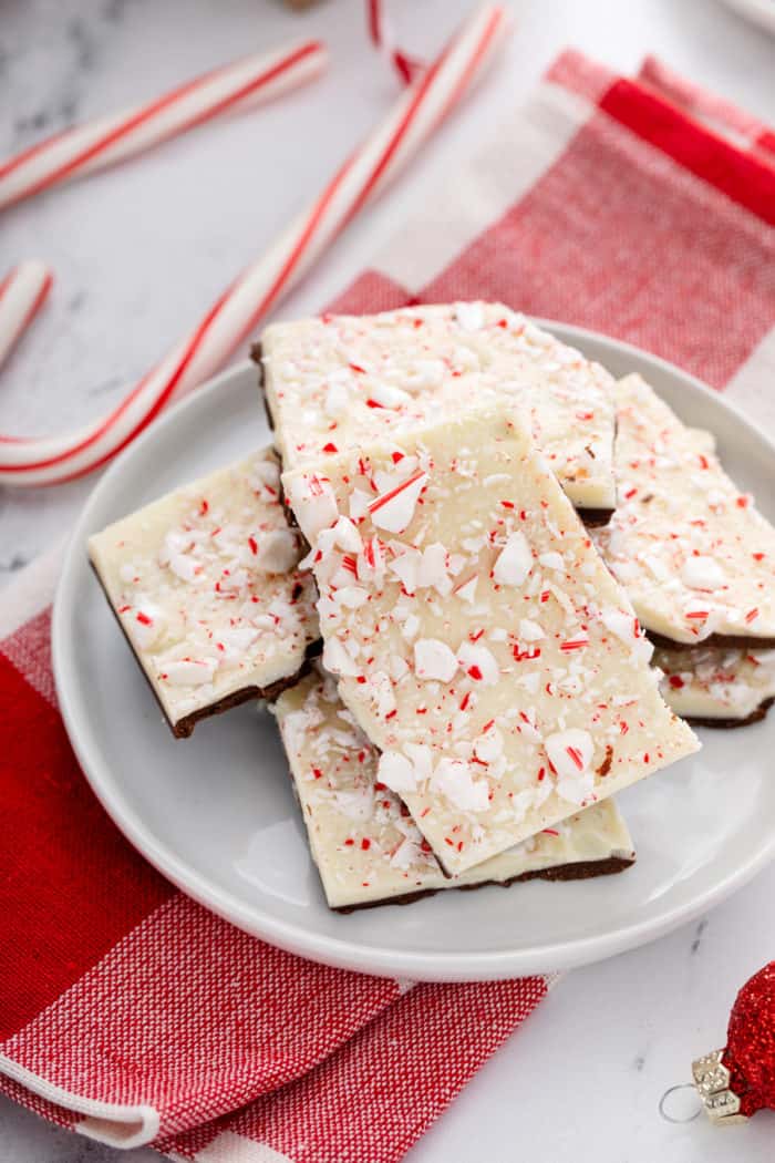 Pieces of peppermint bark arranged on a white plate.