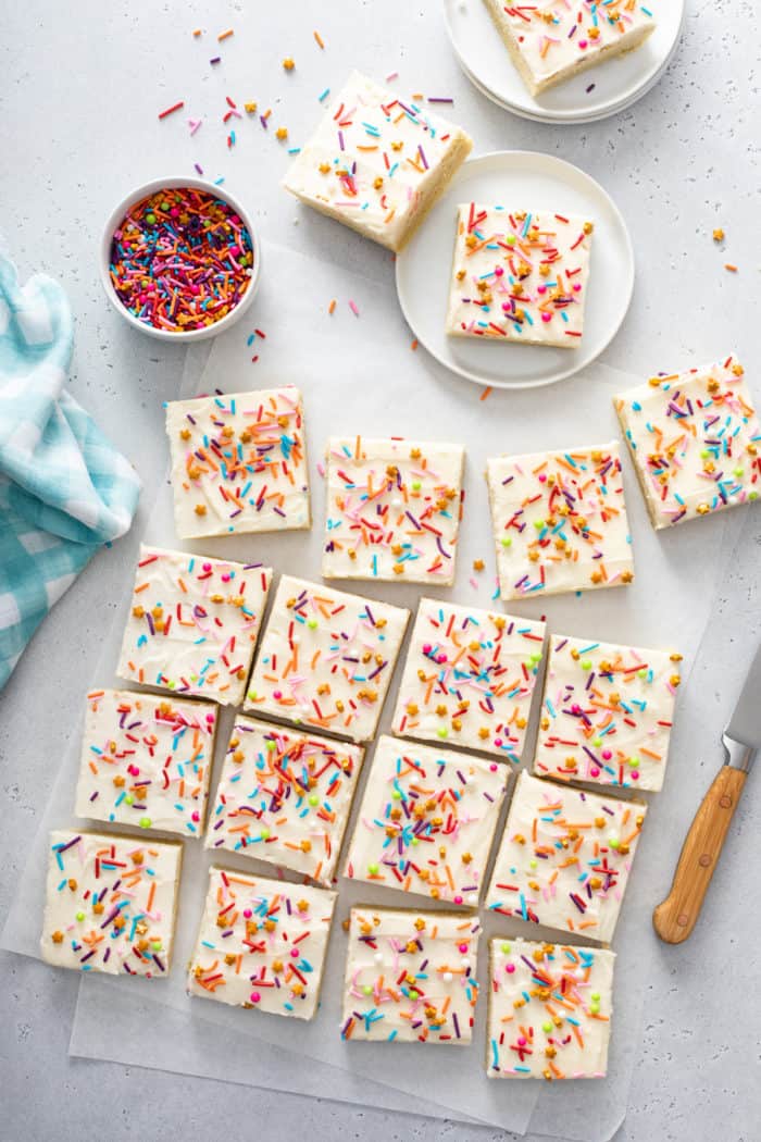 Overhead view of sliced sugar cookie bars topped with a rainbow of sprinkles