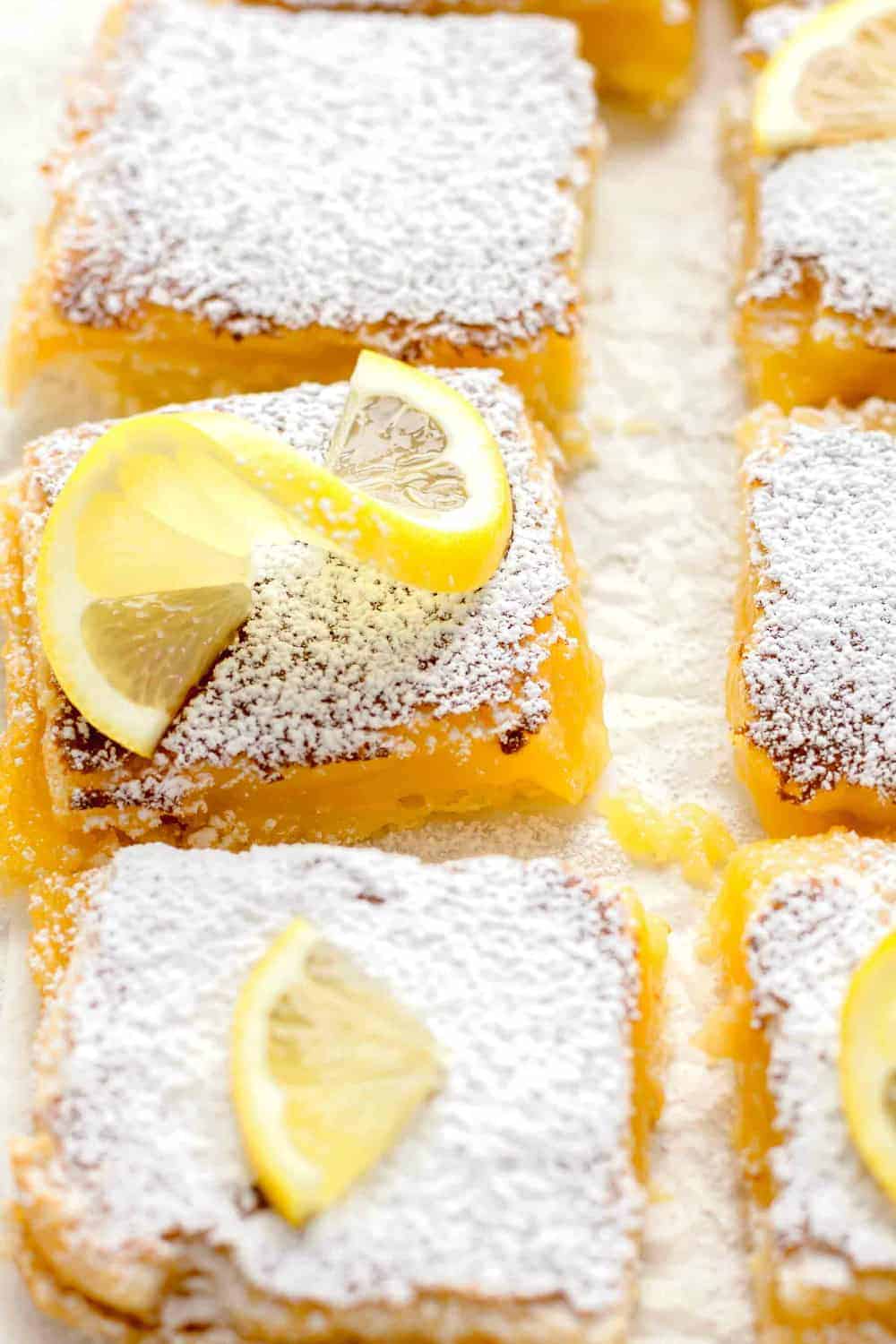 Close-up overhead view of sliced homemade lemon bars dusted with powdered sugar