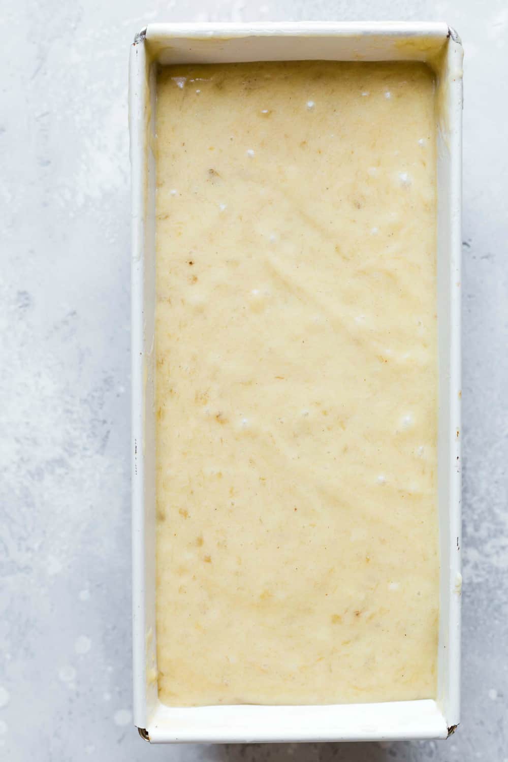 Banana bread batter in a loaf pan, ready to bake