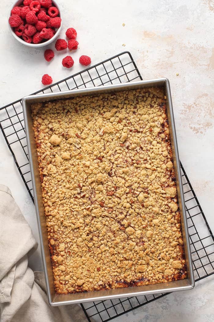 Baked raspberry bars cooling on a wire rack