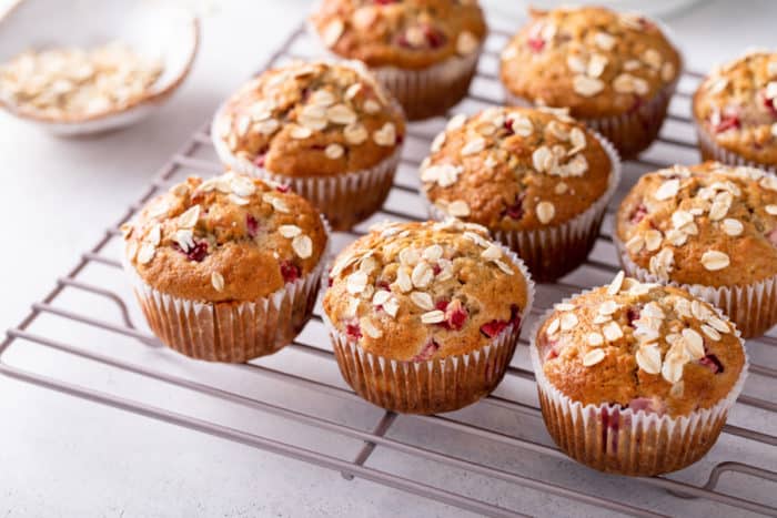 Strawberry banana muffins cooling on a wire rack.