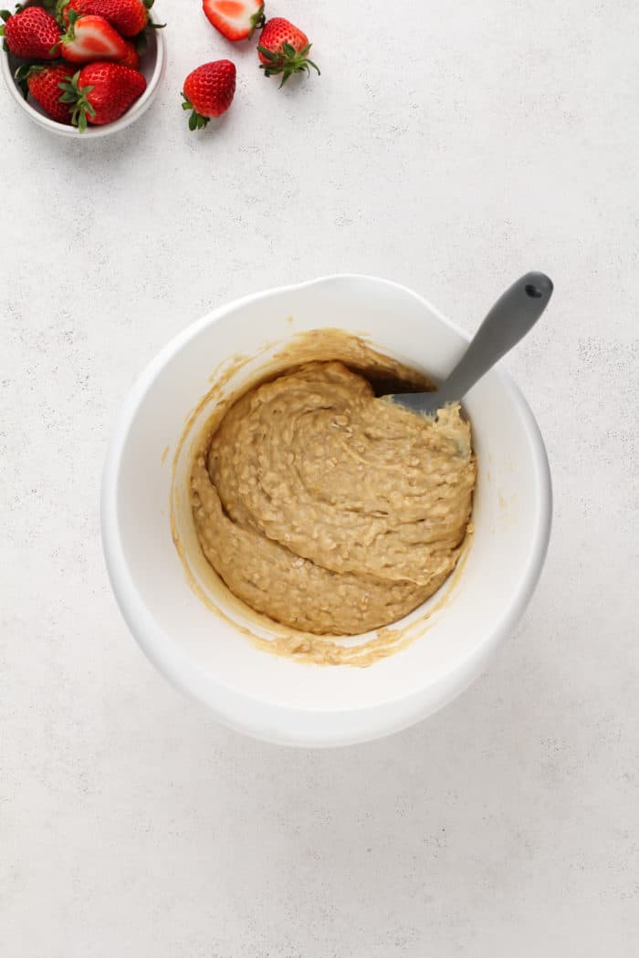 Strawberry banana muffin batter in a white bowl.