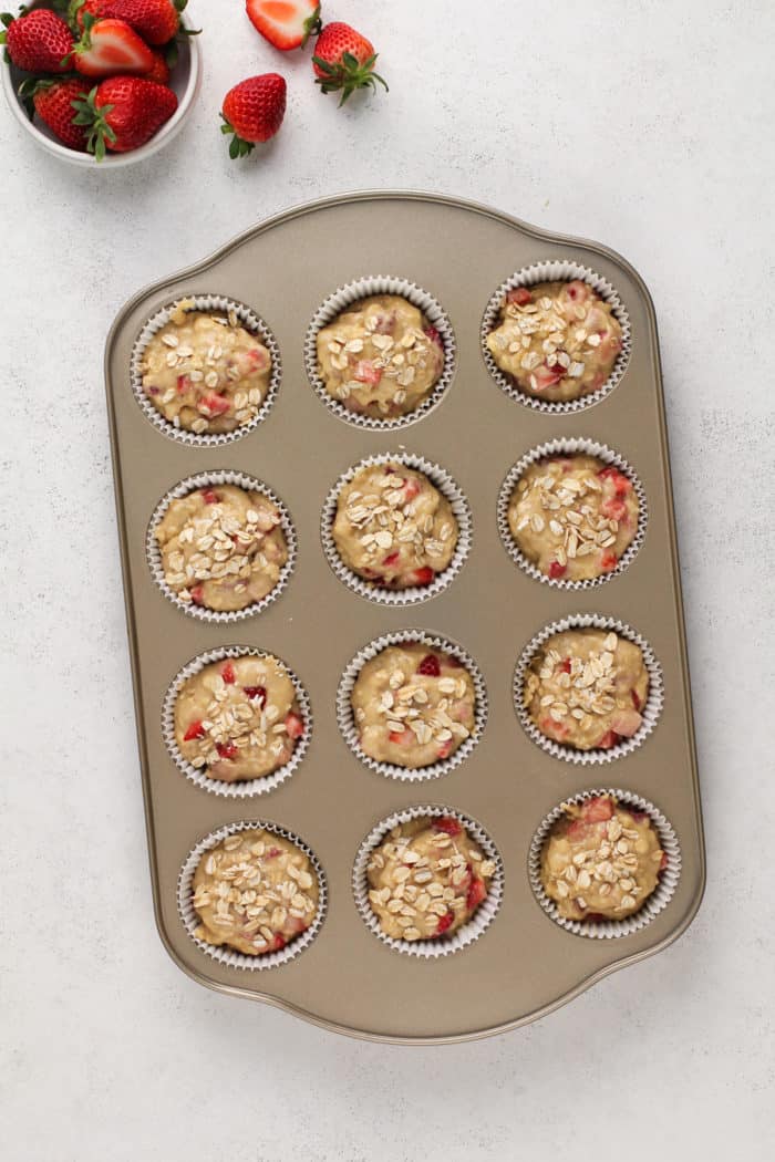 Strawberry banana muffin batter in a muffin tin, ready to go in the oven.