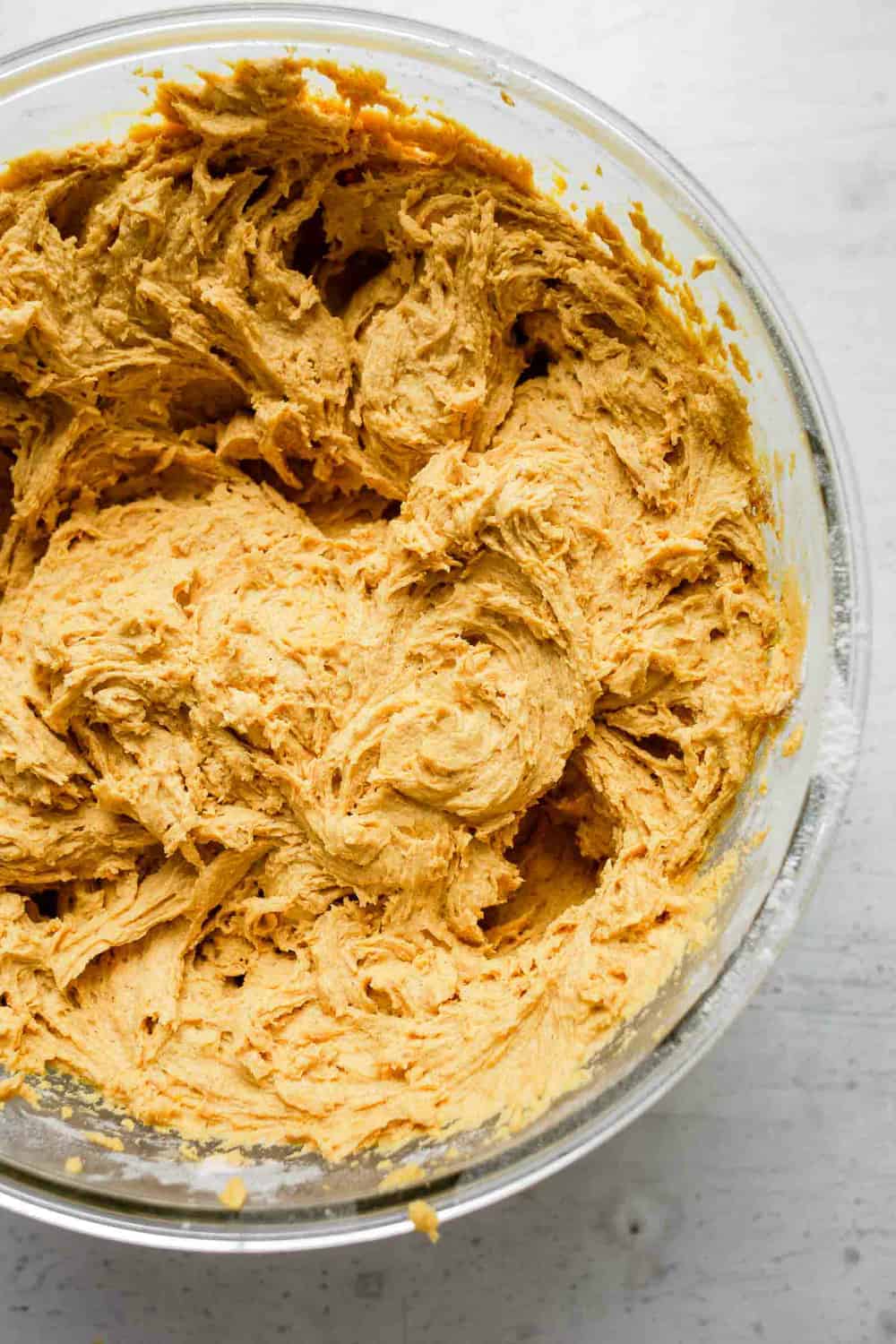 Dough for pumpkin cookies in a glass bowl