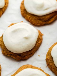 Close up of cream cheese frosting on baked pumpkin cookies
