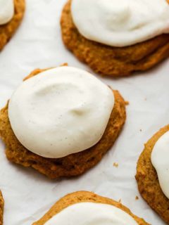 Close up of cream cheese frosting on baked pumpkin cookies