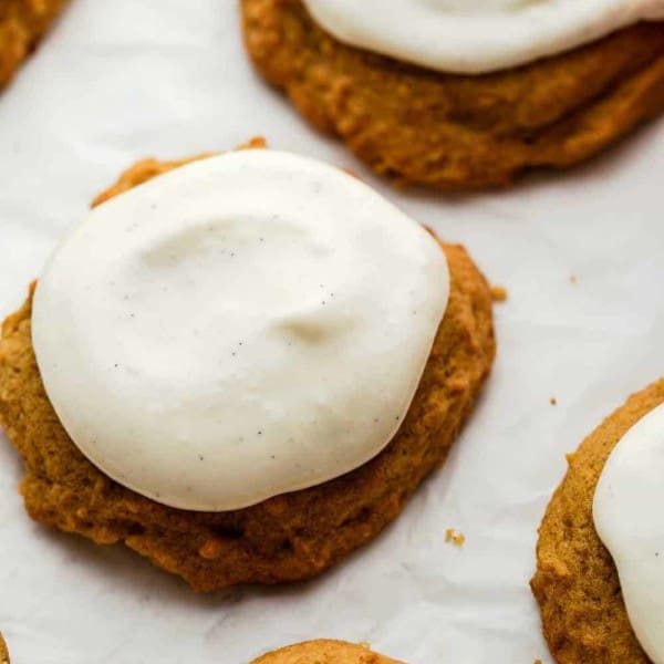 Close up of cream cheese frosting on baked pumpkin cookies