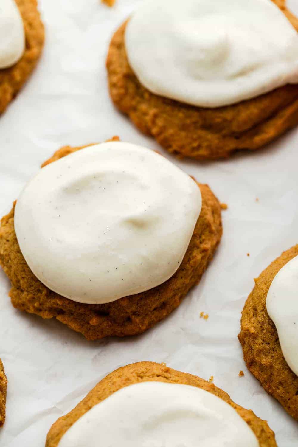 Close up of cream cheese frosting on baked pumpkin cookies