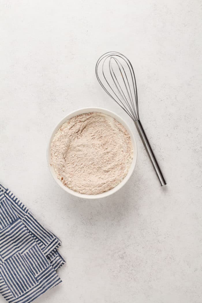 Dry ingredients for carrot cake whisked together in a bowl.