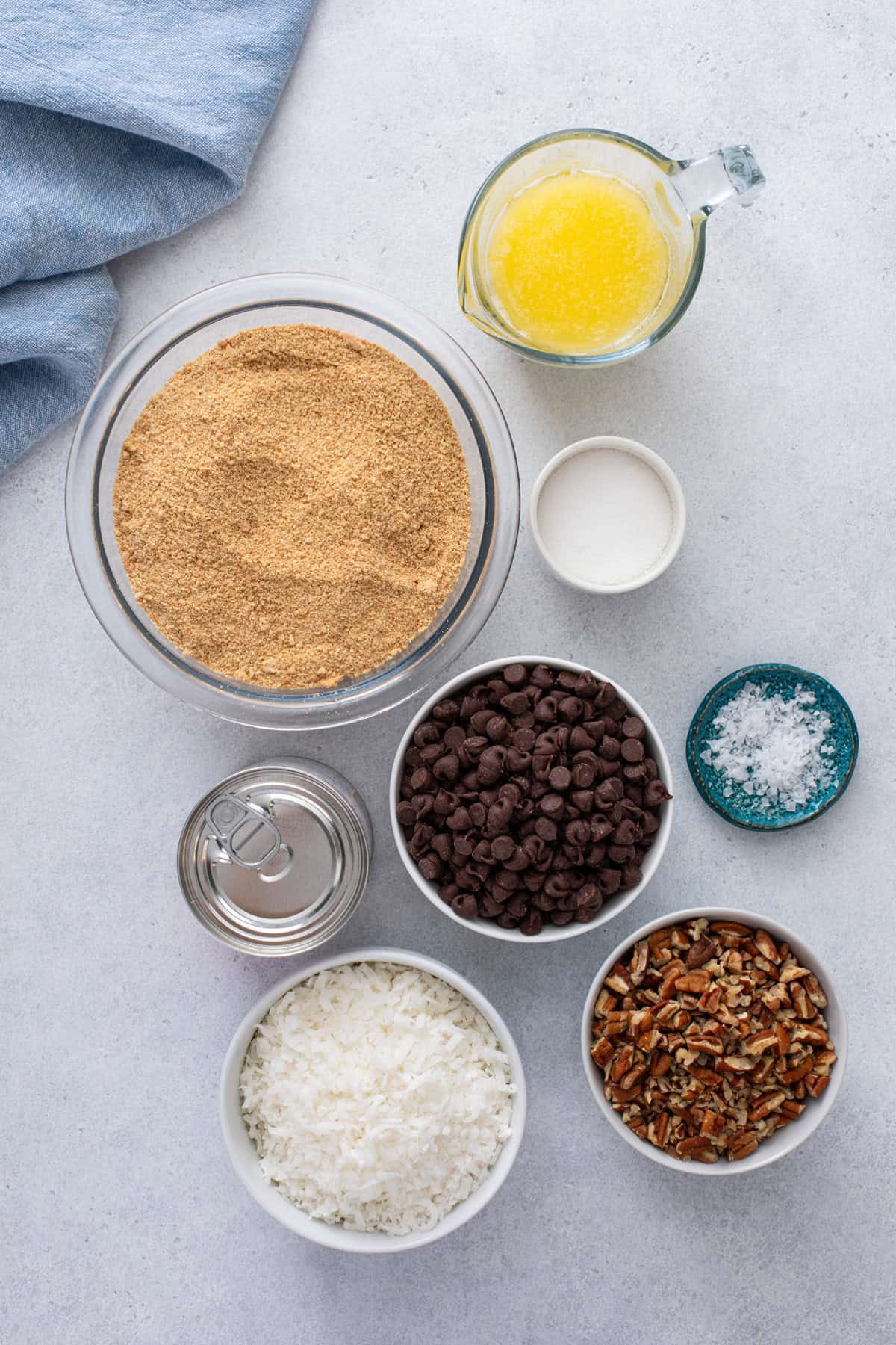Ingredients for magic cookie bars arranged on a countertop.