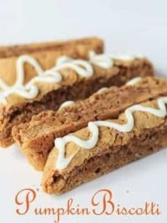 Four pieces of pumpkin biscotti with white frosting drizzled on top