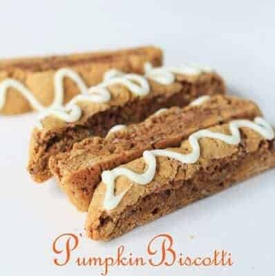 Four pieces of pumpkin biscotti with white frosting drizzled on top