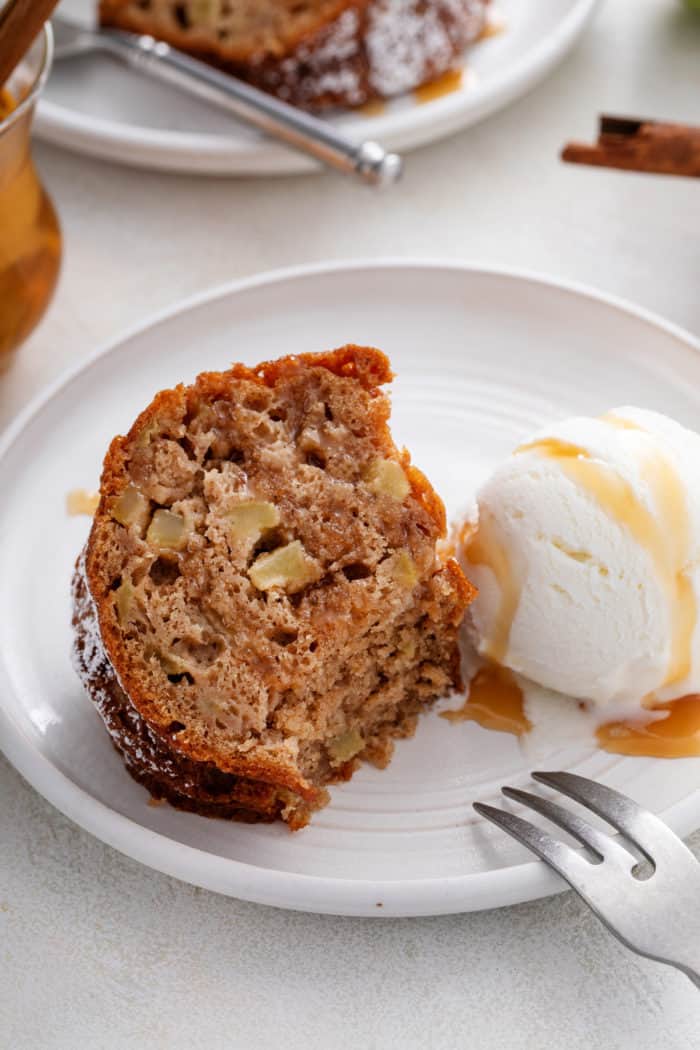 Plated slice of easy apple bundt cake with a bite taken from the corner of the slice.