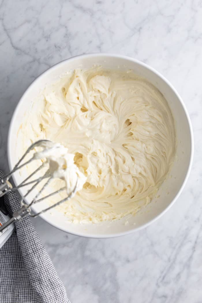 No-bake cheesecake filling in a white mixing bowl.