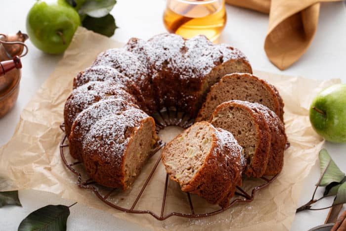 Sliced easy apple bundt cake on a piece of parchment paper.