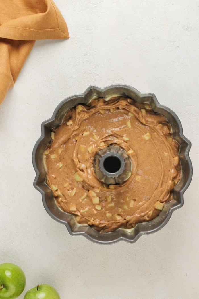 Easy apple bundt cake batter in a bundt pan, ready to go in the oven.