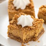 Close up of a pumpkin cheesecake bar with a bite taken out of it