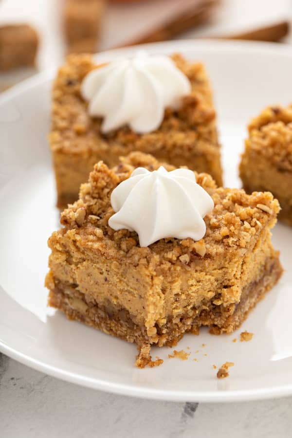Close up of a pumpkin cheesecake bar with a bite taken out of it