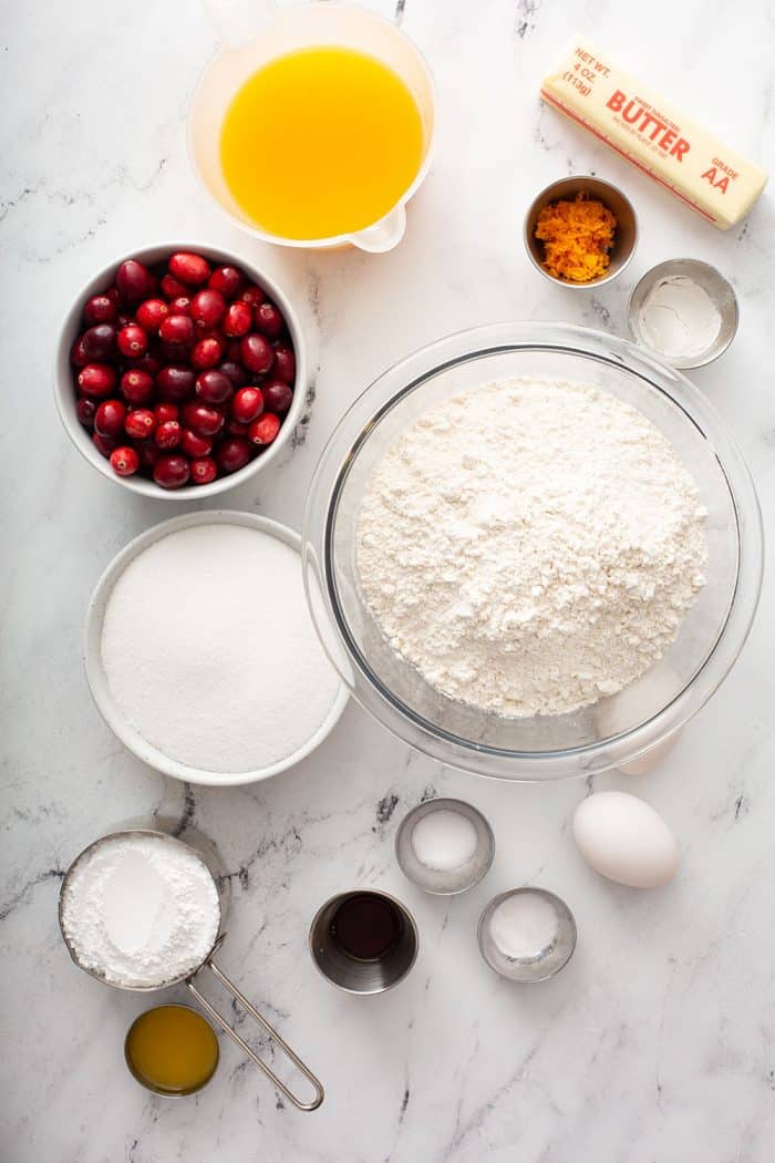 Cranberry orange bundt cake ingredients on a marble countertop