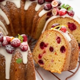 Sliced cranberry orange bundt cake on a wire rack