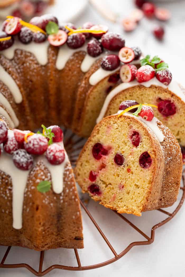 Sliced cranberry orange bundt cake on a wire rack