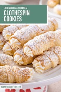 Clothespin cookies dusted with powdered sugar piled on a white cake plate. Text overlay includes recipe name.