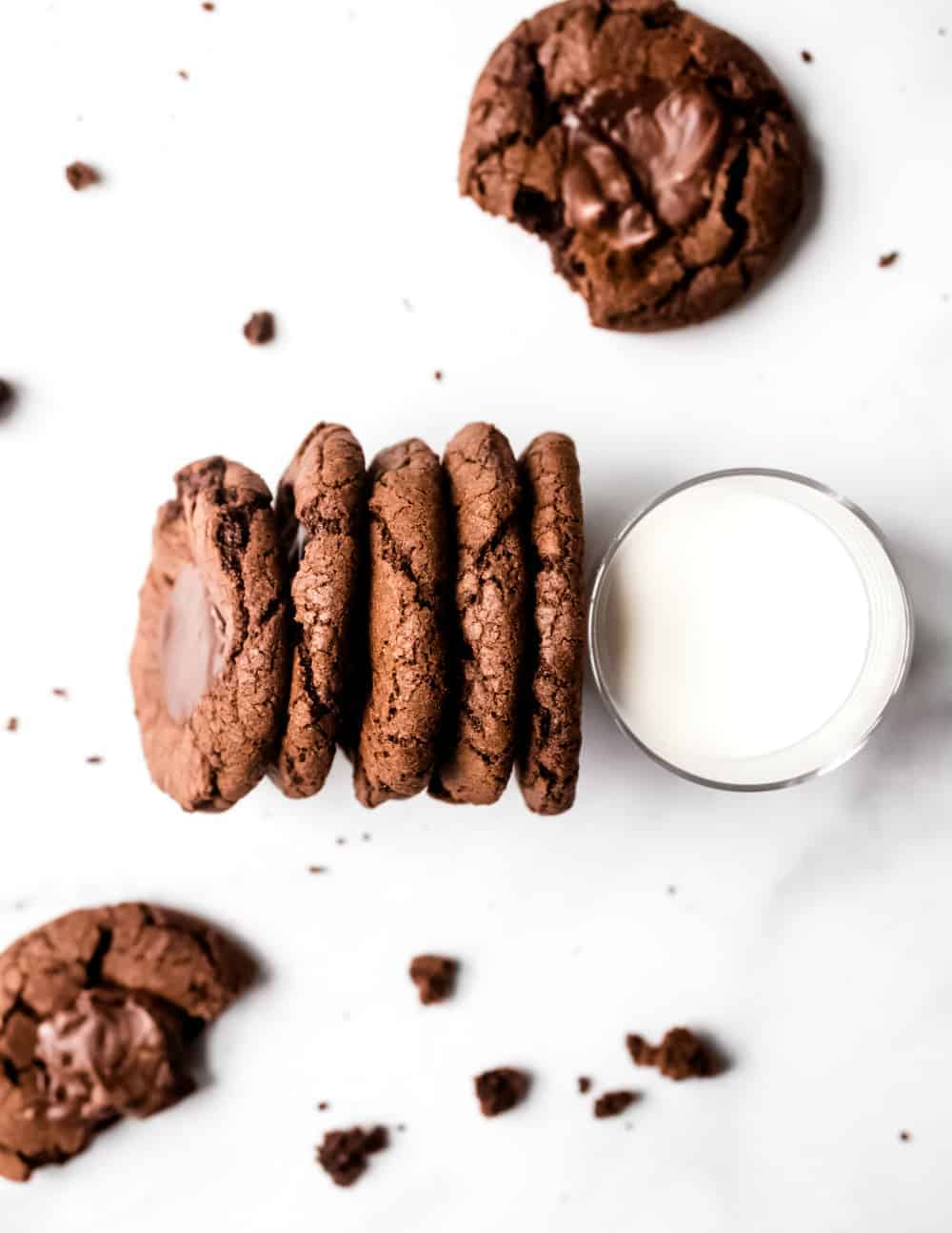 5 Mint chocolate cookies lined up against a glass of milk