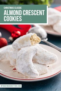 Almond crescent cookies piled on a plate. The top cookie is broken in half to show the texture of the inside. Text overlay includes recipe name.