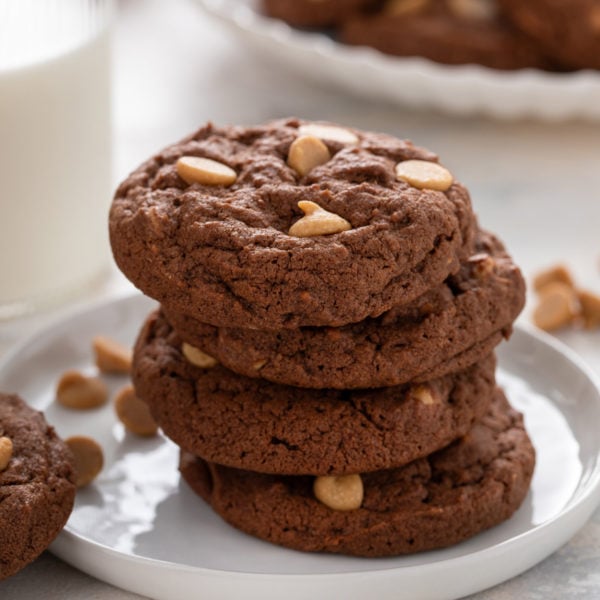 Stack of chocolate peanut butter cookies on a plate.