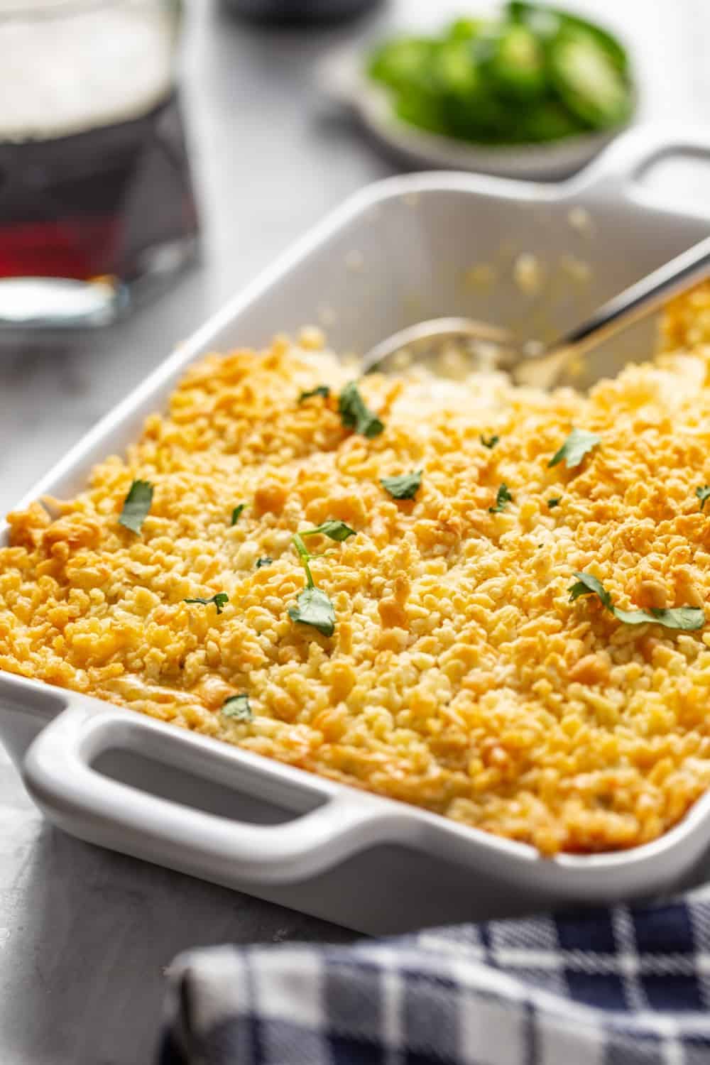 Close up of a white baking dish filled with panko-topped jalapeno popper dip