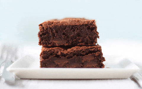 A close up picture of two P. Anderson's brownies stacked on a white plate