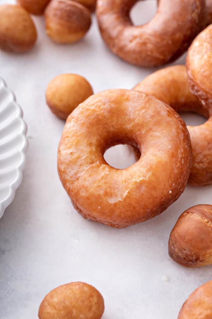 Close up of a homemade doughnut on a light colored countertop.