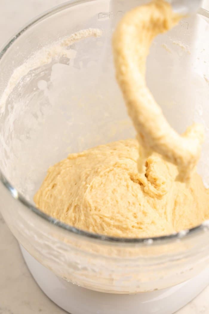 Homemade doughnut dough mixed and kneaded in a stand mixer.