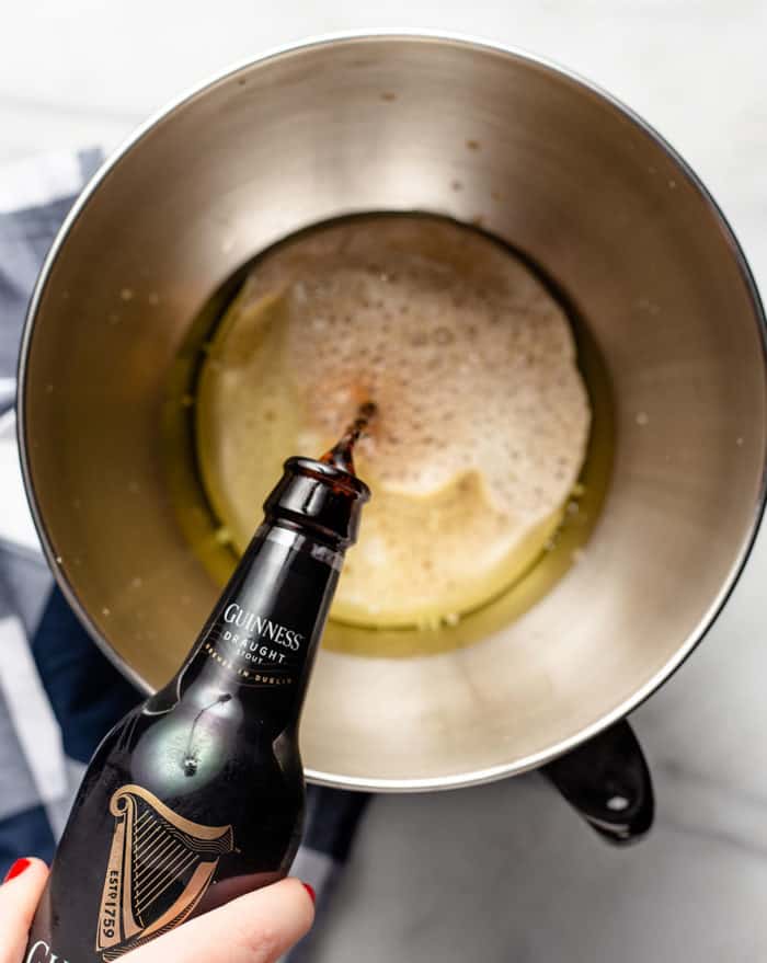 Guinness stout being poured into a mixing bowl for guinness cupcakes