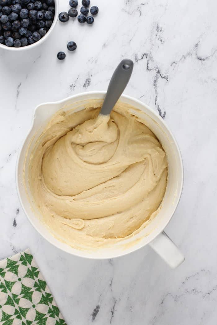 Cake batter base for lemon-blueberry bundt cake in a white mixing bowl.