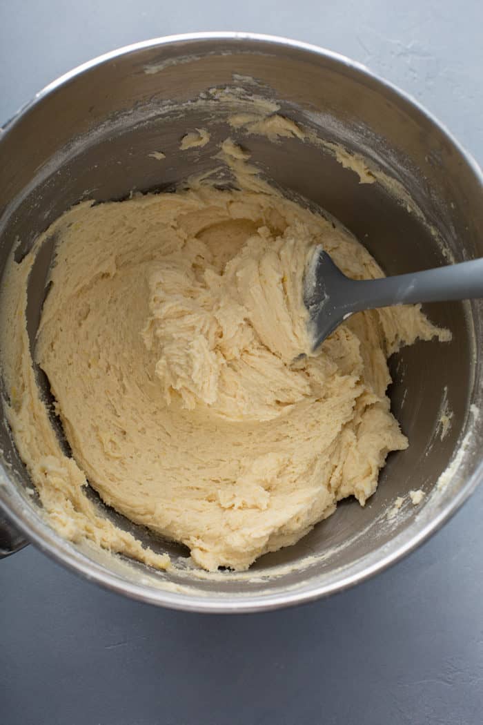 Chewy lemon sugar cookie dough in a metal mixing bowl