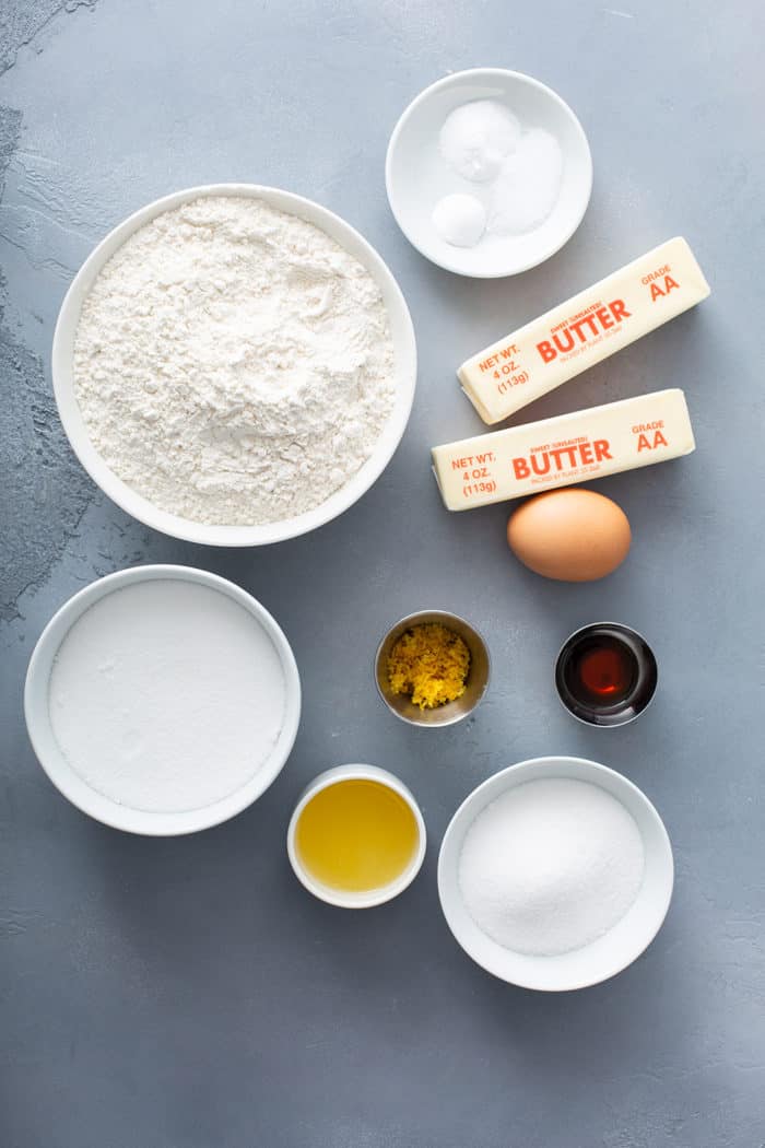 Ingredients for chewy lemon sugar cookies arranged on a gray countertop