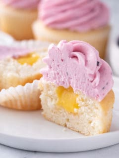 Halved lemon cupcake with blueberry lemon frosting.