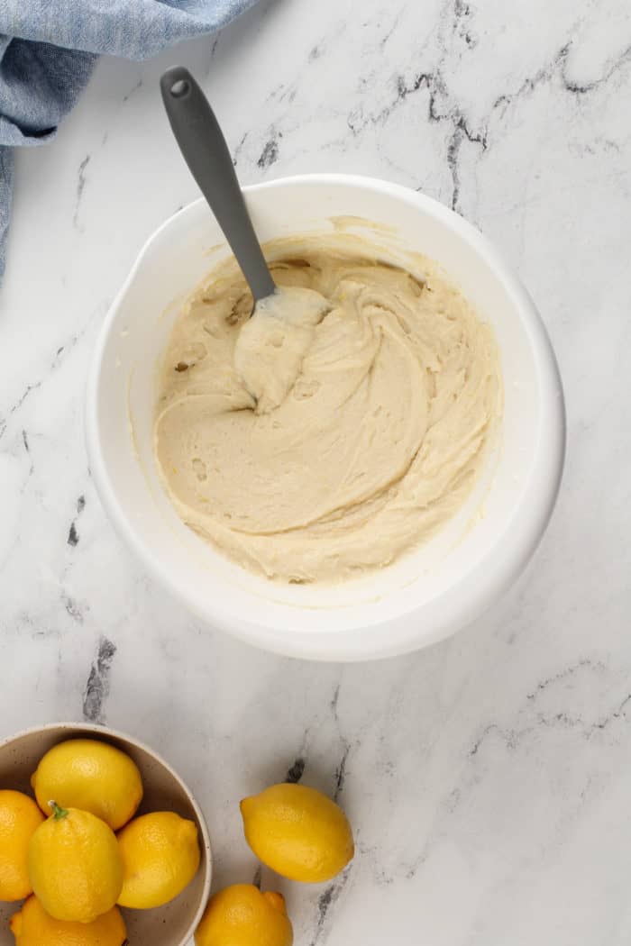 Base of lemon cupcake batter in a white mixing bowl.