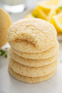 Stack of chewy lemon sugar cookies. The top cookie has a bite taken out of it.