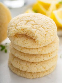 Stack of chewy lemon sugar cookies. The top cookie has a bite taken out of it.