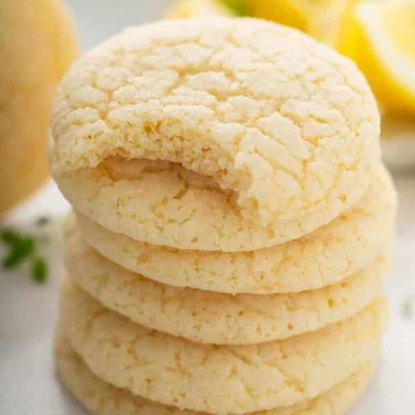 Stack of chewy lemon sugar cookies. The top cookie has a bite taken out of it.