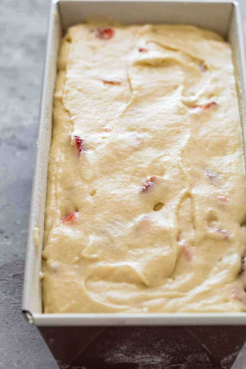 Batter for strawberry bread in a loaf pan, ready to be baked