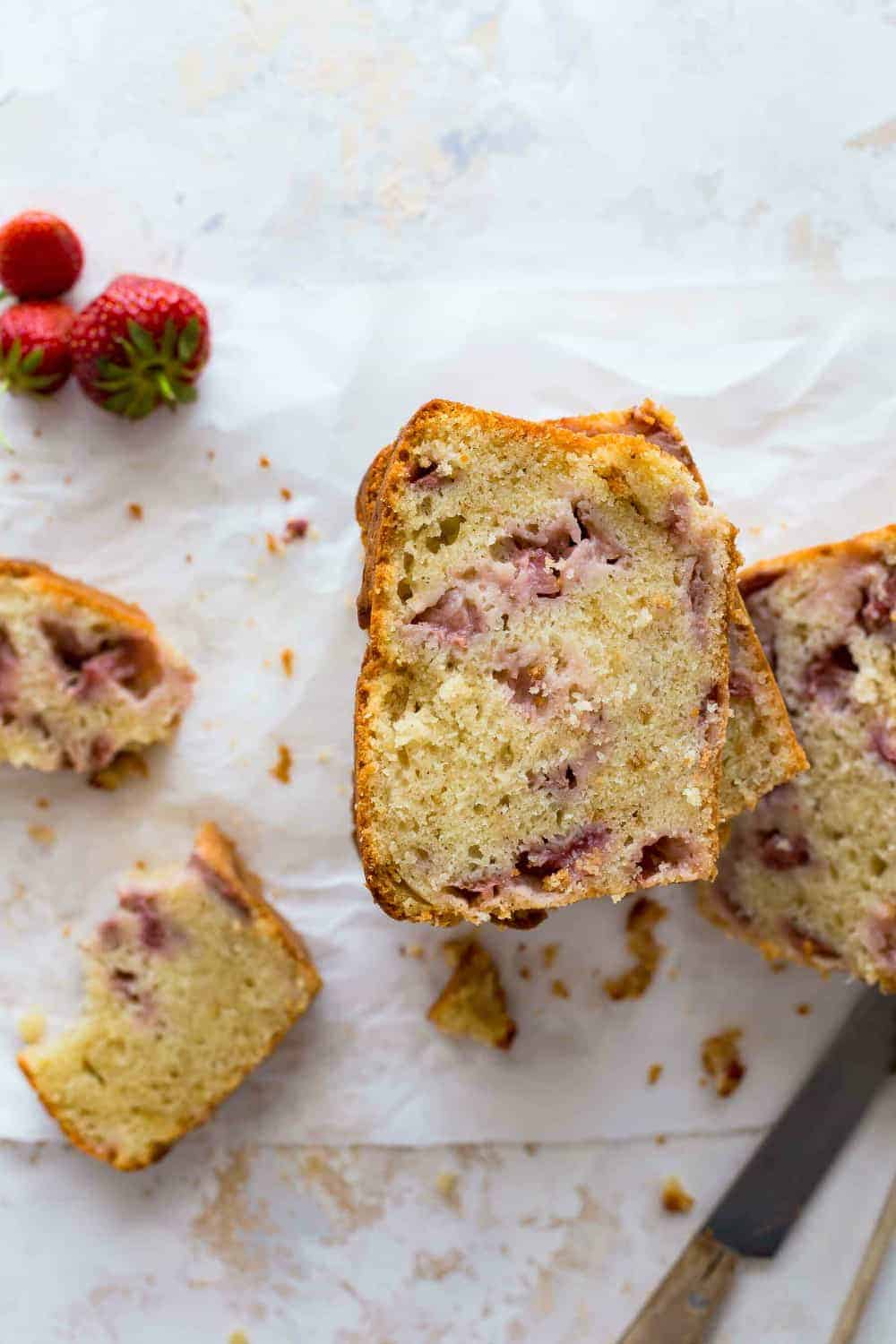 Sliced fresh strawberry bread on a white surface 